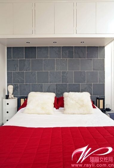 灰色的床头背景墙丰富了空间的造型变化，红色床品给充满现代感的卧室带来温暖的氛围