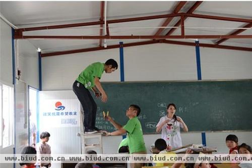 （伊能静亲自协助雪莱特工人为雅安新乡二小学生装灯）